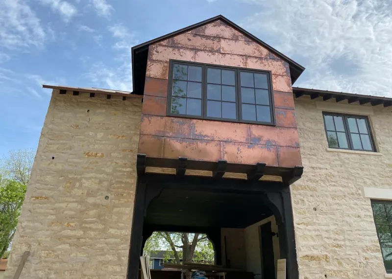 Copper metal panel facade on a stone building for Roof Repair in Catalina Foothills